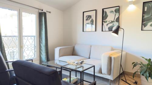 un salon avec un canapé et une table dans l'établissement Appartement climatisé 2 chambres Centre historique, à Aix-en-Provence