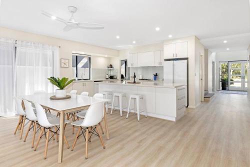 a kitchen and dining room with a table and chairs at 2 Story luxury beach house in Geographe