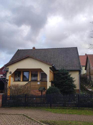 a house with a fence in front of it at Ferienhaus Anna in Allrode
