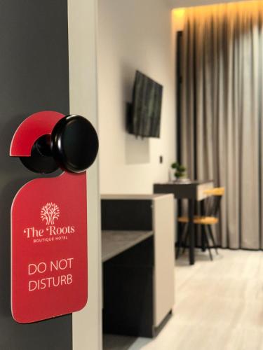 a do not disturb sign on a door in a room at The Roots Boutique Hotel in Shkodër