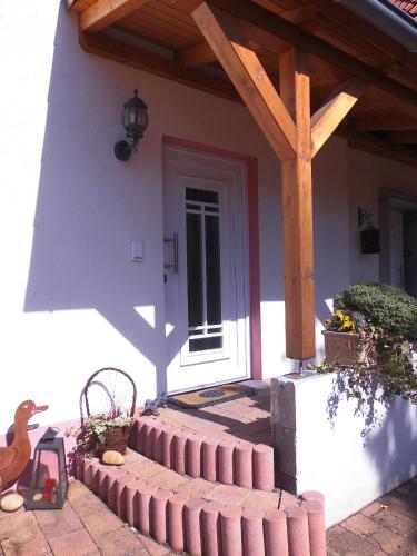 a front door of a house with a wooden roof at Marie's Apartment in Detmold
