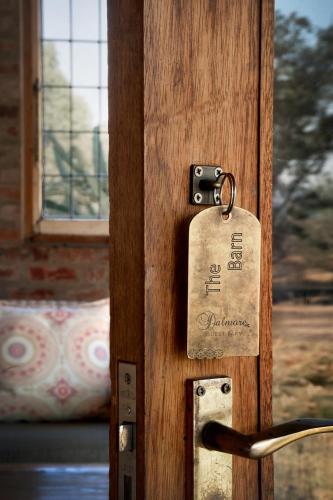 a wooden door with a tag on it at Dalmore Guest Farm in Bergville