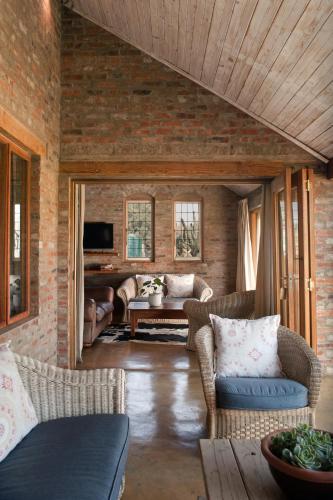 a living room with couches and a table at Dalmore Guest Farm in Bergville