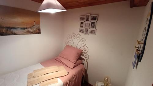 a bedroom with a bed with a pink pillow at Orion Guesthouse Telhado in Fundão