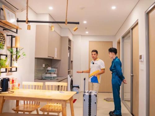 two men standing in the kitchen of a house at The Song Vung Tau Homestay - VTLand in Vung Tau