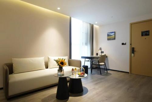 a living room with a couch and a table at Atour Hotel (Xi'an Xiaozhainan, Qujiang Convention and Exhibition Center) in Xi'an