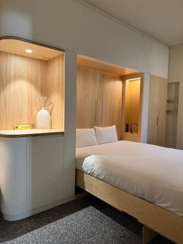 a bedroom with a large bed in a room at Hôtel Life Bordeaux Gare - BG in Bordeaux