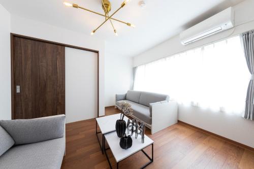 a living room with a couch and a table at Kosumosu in Tokyo