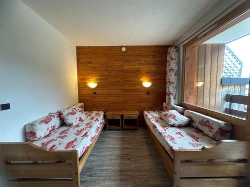 une petite chambre avec deux lits et une fenêtre dans l'établissement Studio divisible rénové, pied des pistes, balcon, 4 pers., La Plagne - FR-1-181-1104, à Plagne Bellecôte