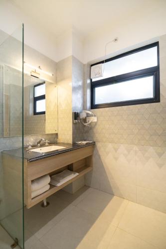 a bathroom with a sink and a glass shower at Marten's Wilderness Retreat in Lansdowne