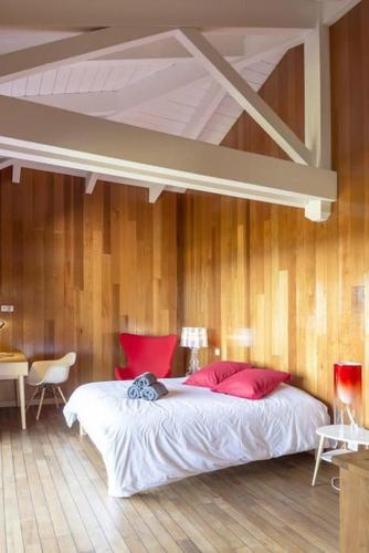 une chambre avec un grand lit avec des oreillers rouges dans l'établissement Villa Palombaggia, à Porto-Vecchio