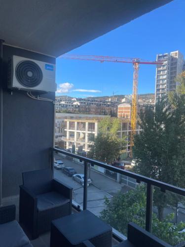 Habitación con balcón con vistas a una grúa. en Demax apartment, en Tiflis
