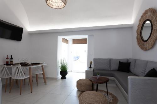 a living room with a couch and a table at Villa Izabela in Santorini