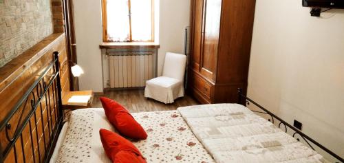 Fara NovareseにあるBorgo Antico Chalet Appartamentiのベッドルーム1室(ベッド2台、椅子付)