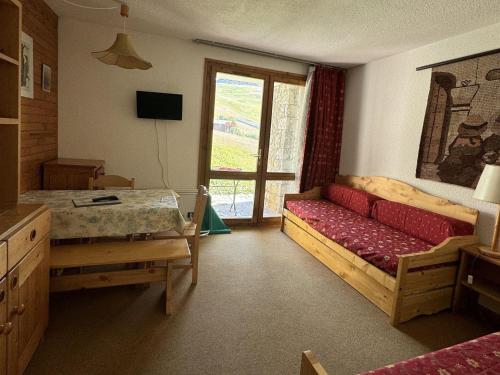 - une chambre avec un canapé, une table et une fenêtre dans l'établissement Studio Fonctionnel avec Terrasse, Accès Direct aux Pistes, Belle Plagne - FR-1-181-2219, à La Plagne Tarentaise