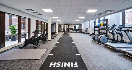 a gym with rows of treadmills and machines at For Students Only York House Nottingham in Nottingham