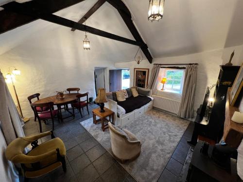 a living room with a couch and a table at Private Thatched Cottage - with views in Letterkenny