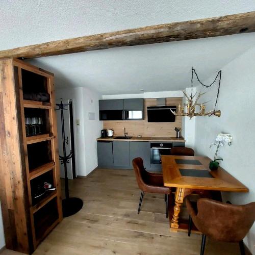 a kitchen and dining room with a table and chairs at FeWo's und Apartment's Schöneck in Davos
