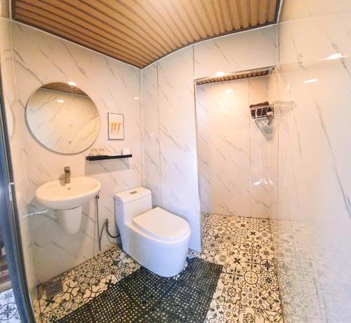 a bathroom with a toilet and a sink at Adachi Farmstay Bảo Lộc in Bao Loc