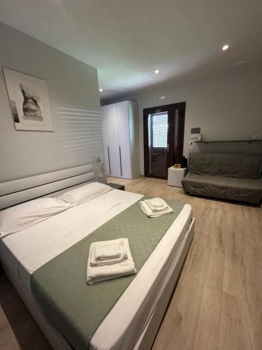 a bedroom with a large bed with towels on it at Agriturismo da Michele e Carmela di Voli Patrizia in Donoratico