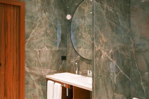 a bathroom with a sink and a mirror at Hotel Belvedere in Bellagio