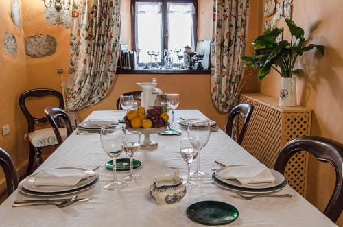 a table with a white table cloth and glasses at Hotel Rural Las Calas in Vega de San Mateo