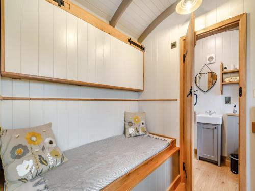 a small bedroom with a bed in a tiny house at The Swaledale Hut - Uk40151 in Rathmell