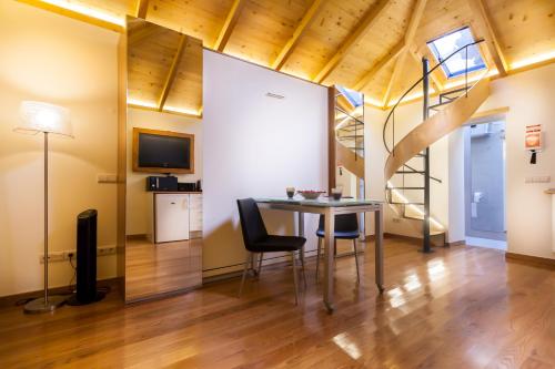 a room with a table and chairs and a tv at Sao Thiago House Madeira in Funchal
