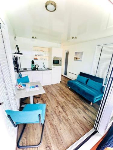 a living room with blue chairs and a couch at ''Statia'' Cozy & Romantic Houseboat in Maastricht in Maastricht