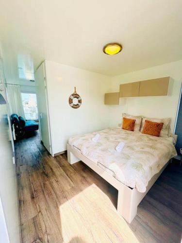 a bedroom with a white bed in a room at ''Statia'' Cozy & Romantic Houseboat in Maastricht in Maastricht