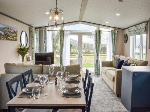 a dining room with a table and a couch at Dodd - Uk42499 in Bassenthwaite