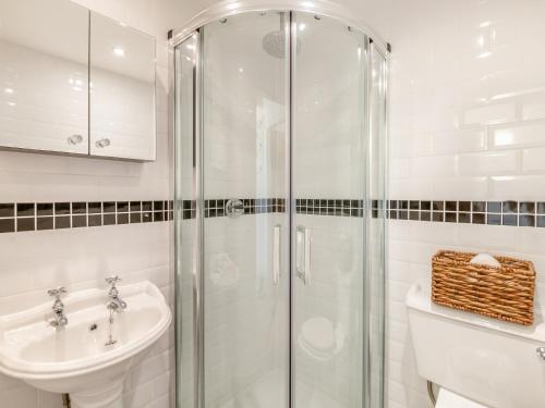 a bathroom with a shower and a sink and a toilet at Beverley House - Uk43519 in Thornton Dale
