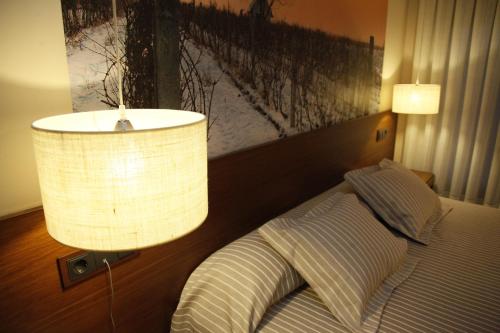 a bedroom with a bed with a lamp on it at Casa Lola in Rueda