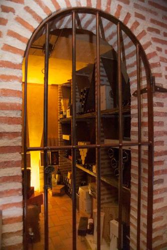 a large glass window in a room with a brick wall at Casa Lola in Rueda