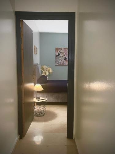 a door to a room with a bed and a table at Villa Rose Marie Calme et Grands Espaces in Le François