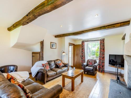 a living room with leather couches and a tv at Warth House - Uk44209 in Ingleton 