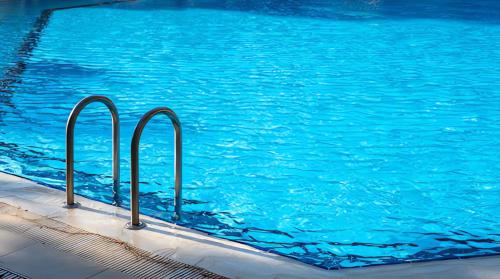 a large blue swimming pool with blue water at La Quinta Inn by Wyndham Colorado Springs Garden of the Gods in Colorado Springs