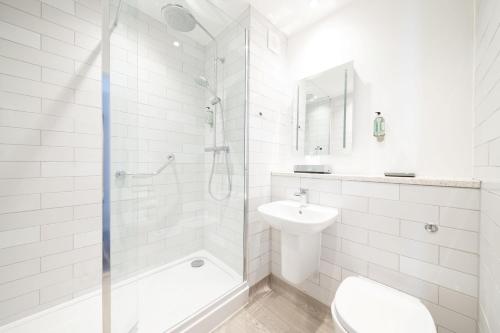 a bathroom with a shower and a toilet and a sink at Toby Carvery Beckenham by Innkeeper's Collection in Bromley