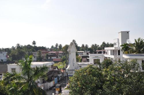 an aerial view of a city with buildings and trees at Daffodils Spice Court in Cochin