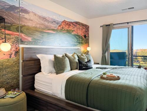 a bedroom with a large bed with a painting on the wall at Stargazer – Luxury Condo, Rooftop Views, Private Hot Tub in St. George