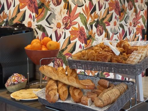 zwei Körbe Brot und Gebäck auf einem Tisch in der Unterkunft Hotel Restaurant de la Poste in Saint-Just-en-Chevalet