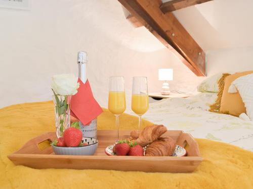 a tray of food and two glasses of champagne at Y Stabl - Uk35032 in Carmarthen