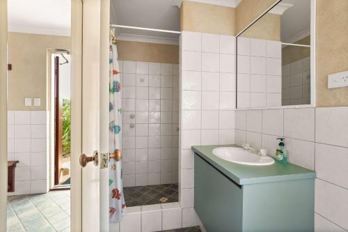 a bathroom with a sink and a mirror at Carinya Cove - swimming pool, pet friendly, fireplace in Dunsborough