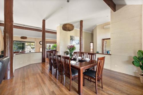 a dining room with a wooden table and chairs at Carinya Cove - swimming pool, pet friendly, fireplace in Dunsborough