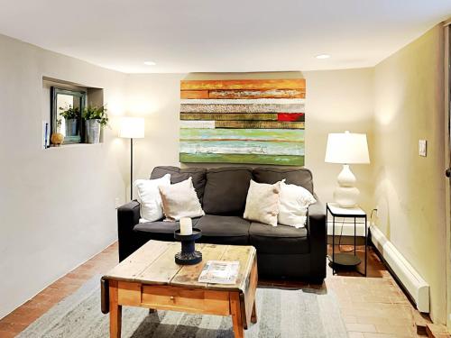 a living room with a couch and a table at Casa en Canyon in Santa Fe