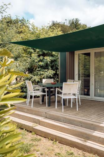 a patio with a table and chairs on a deck at Domaine de Verdagne in Gassin