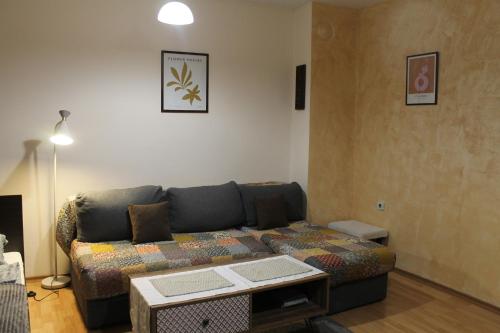 a living room with a couch and a table at Quiet central studio in Pazardzhik