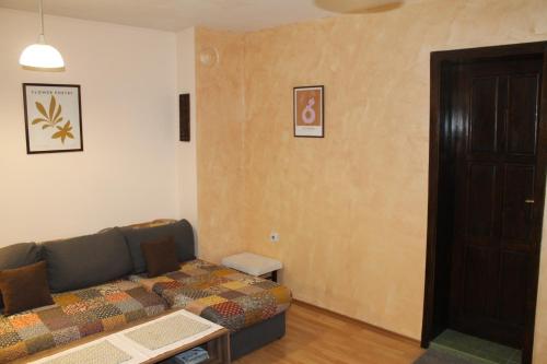 a living room with a couch and a door at Quiet central studio in Pazardzhik