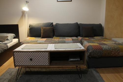 a living room with a couch and a table at Quiet central studio in Pazardzhik
