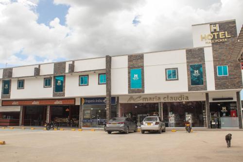 a large building with cars parked in a parking lot at Hotel Mall plaza in Santa Marta